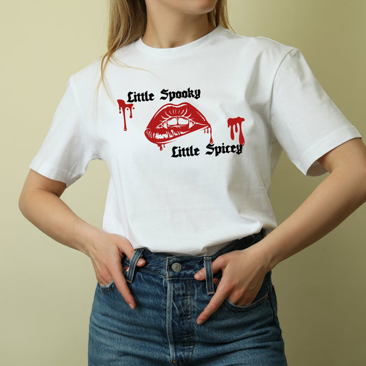 A person wearing a white t-shirt with 'Lil Spooky' and 'Lil Spicy' text and a red splash graphic design.